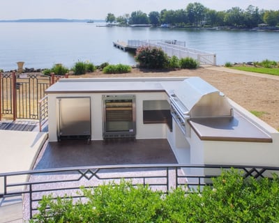 Outdoor kitchen with built-in grill and appliances.