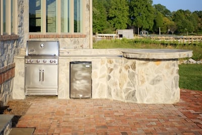 BBQ grill encased in stone on patio