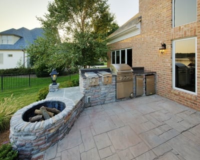 custom stone fire pit with grill encased in stone
