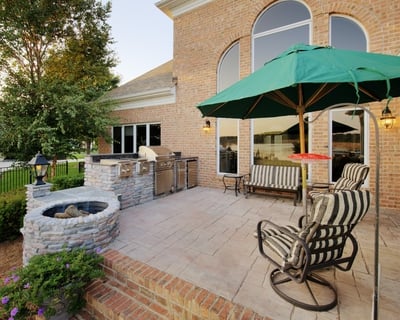 patio kitchen with grill and fire pit made of stone